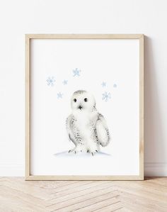 an owl is sitting on the floor in front of a white wall with snowflakes