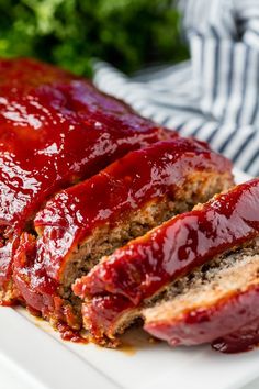 sliced meatloaf on a plate with ketchup