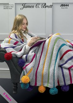 a woman sitting on a chair under a blanket