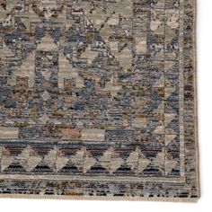 an old rug with many different colors and patterns on the carpet, including blue, beige,