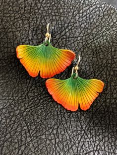 "Ginko Leaf Leather Earrings with Sterling Silver Ear Wire.   1  3/8 inches long from the top of the ear wire to the bottom of the leaf.  1  3/8\" wide   Each earring is hand molded from leather, dyed, painted, clear coated and assembled.  Very Light Weight, Comfortable to wear and very durable    Inspired by real autumn leaves.    I hope you enjoy autumn all year long with these colorful earrings. Please note that every piece is made by hand and may vary slightly in color and shape.  Also note thats colors may appear slightly brighter, darker, or altered depending on different screen monitors or devices.  I've done my best to Photograph the product as accurately as possible. **Please ask any questions before you buy" Handmade Leaf-shaped Earrings, Unique Nickel-free Leaf-shaped Earrings, Adjustable Hand-painted Red Jewelry, Adjustable Hand Painted Red Jewelry, Adjustable Red Hand-painted Jewelry, Unique Nickel-free Leaf-shaped Jewelry, Multicolor Leaf Shaped Jewelry For Gifts, Multicolor Leaf-shaped Jewelry Gift, Multicolor Leaf-shaped Earrings For Gift