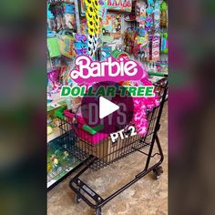 a shopping cart in a store with barbie dolls and other toys behind it that says barbie dollar tree dfs