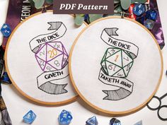 two embroidered hoops with dice and the words df pattern next to each other