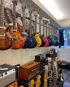 guitars and amps are lined up on the wall