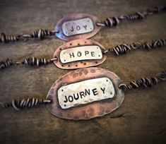 three necklaces with words on them that say joy, hope, and journey