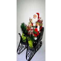 a santa clause sitting in a sleigh with presents