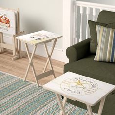 a living room with a green chair and two small tables on top of each other