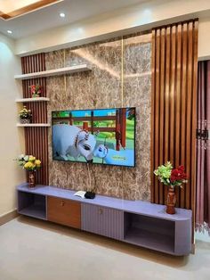 a large flat screen tv mounted to the side of a wall in a living room