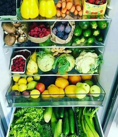 a refrigerator filled with lots of different types of fruits and vegetables on it's shelves