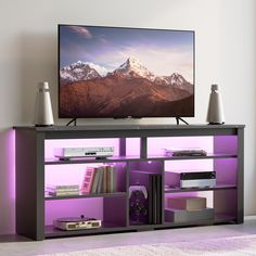 a flat screen tv sitting on top of a purple shelf