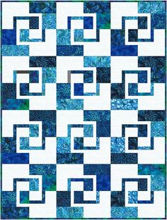 a blue and white quilt with an abstract design on the front, in square shape