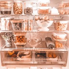 an open refrigerator filled with lots of food and containers full of vegetables, fruits and other items