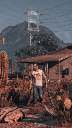 a man standing in the middle of a desert next to a house and cactus plants