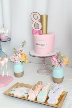 a table topped with lots of cakes and cookies