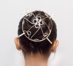 "This is a perfect hair accessory for any special occasion.  Arch silverhair  bun cage ,for long or thick hair . Hammered and textured to wires and swirled gives the piece strength to maintain its shape. The bun has a deep dome curve which is 2.5\" in depth  and The size in the picture ,model is wearing on medium size is 3.5\"diameters. There are two pins with it. ------------------------------------------------------------------------------------------------------------------------------------- Hair Bun Pin, Brass Hair Pin, Celtic Hair, Hair Accessories Bun, Hair Forks, Ponytail Wrap, Hair Bun Maker, Bun Holder, Organizing Hair Accessories