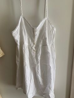 Super sweet sheer cotton babydoll nightgown or top. Victoria's Secret from the late 1980's. Lace trim. Very simple and sweet! Tagged petite small. Please use measurements.  Straps do not adjust.  Bust flat is 16 inches measured at the back. Length is 33 inches.  Pinhole mark on front right  bodice near buttons   pinhole near bottom of right strap on bodice  dime size very faint stain near right strap on bodice  Buttons up front of bodice  No returns. Final sale. Sold as is. 🌺 Summer Camisole Nightgown With Lace Trim, White Ruffled Nightgown For The Beach, Cottagecore White Sleepwear With Lace Trim, White Cottagecore Sleepwear With Lace Trim, Cottagecore White Nightgown With Lace Trim, Summer Cotton Sleepwear With Delicate Lace, White Broderie Anglaise Nightgown For Sleep, Summer Nightgown With Delicate Lace For Bedtime, Summer Delicate Lace Nightgown For Bedtime