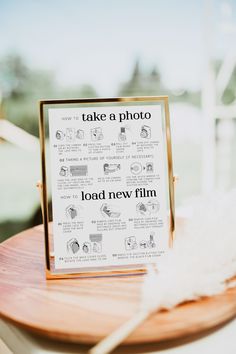 a table with a sign that says take a photo, load new film on it