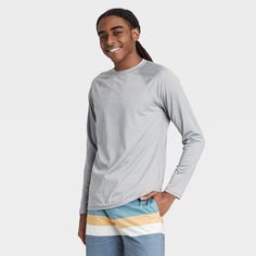 Stay comfortable on or in the water with the Regular Fit Long-Sleeve Rash Guard Swim Shirt from Goodfellow & Co™. This men’s rash guard features a regular fit with a solid hue for a no-nonsense look that’s perfect for hot days on the water. It’s made from soft fabric with added spandex for improved mobility and comfort, while UPF 50+ sun-blocking protection helps keep your skin safe from harmful sun rays. Whether you’re wading through the water or relaxing on the boat, this solid-color rash guar Casual Long Sleeve Tops For Water Sports, Casual Crew Neck Rash Guard For Water Sports, Casual Rash Guard With Upf 50+ For Outdoor Activities, Casual Long Sleeve Rash Guard With Upf 50+, Casual Rash Guard For Surfing With Upf 50+, Long Sleeve Moisture-wicking Rash Guard For Summer, Moisture-wicking Long Sleeve Rash Guard For Summer, Summer Long Sleeve Moisture-wicking Rash Guard, Long Sleeve Tops For Water Sports In Summer