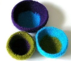 three different colored bowls sitting next to each other on a white surface with one green and the other blue