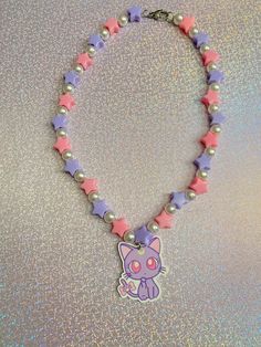 If you love pastel colors and cute jewelry, then this kawaii beaded necklace is the perfect addition to your aesthetic! Consisting of purple & pink stars with pearls, and a cute cat, this necklace can't be found anywhere else but here✨. Check out our beaded necklaces section to find more unique designs that are truly OOAK. *Stainless steel material only *Pendant is lightweight *Choose from 3 different lengths (prices vary) If you have any questions, please don't hesitate to ask! We are friendly:) Visit our official website: www.yeetincolorboutique.com and follow us on Instagram: @yeetincolorboutique Pink Handmade Sweet Necklace, Handmade Pink Sweet Necklace, Handmade Sweet Pink Necklace, Pink Round Beads Kawaii Jewelry, Cute Multicolor Charm Necklaces, Playful Pink Charm Necklaces For Jewelry Makers, Cute Pink Charm Necklace With Heart Beads, Cute Pink Heart Beaded Necklaces, Cute Purple Beaded Necklace