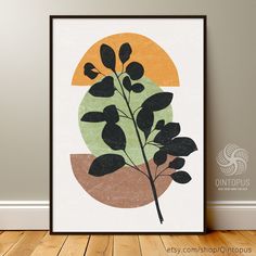 a poster with a plant in front of it on a wall next to a wooden floor