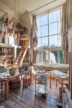 an old room with lots of clutter on the floor and shelves full of books