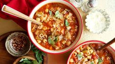 two bowls of pasta soup on a table