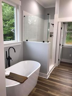 a white bath tub sitting next to a window