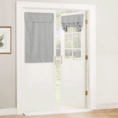 an open door with two towels hanging on the side