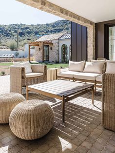 an outdoor living area with wicker furniture