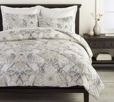 a bed covered in a white and blue comforter