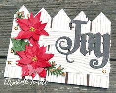 a card with poinsettis and the word joy on it