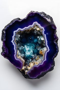 an amethorate with blue and purple colors on it's side, surrounded by other rocks