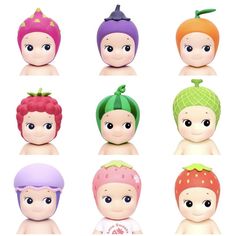 a group of small dolls with different colored hair and hats on their heads, all in various shapes and sizes