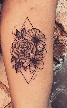 a black and white flower tattoo on the leg