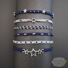 Welcome to Stormy Day Crafts, where style meets celestial charm! Introducing our Midnight Stars Stackable Friendship Bracelet Sets - crafted to add a touch of enchantment to your everyday moments. ⭐ Set of 6, Set of 3, and Individual Bracelets: Choose from our versatile options: Full set of all 6 bracelets, a set of 3 bracelets, or individual bracelets to suit your preferences. Mix and match for a ook that's uniquely yours. In Set A 1: Dark Blue with Silver Beads 2: Light Grey with Blue Beads 3: Blue Friendship Bracelet Patterns, Trio Friendship Bracelets, Friendship Bead Bracelets, Star Friendship Bracelet, Trio Bracelets, Blue Friendship Bracelet, Dark Blue Bracelet, Space Bracelet, Midnight Mayhem