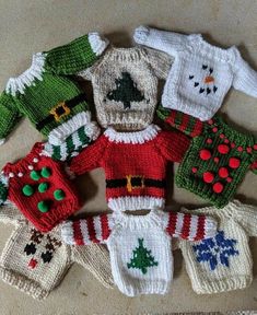 knitted christmas sweaters and mittens laid out on the floor