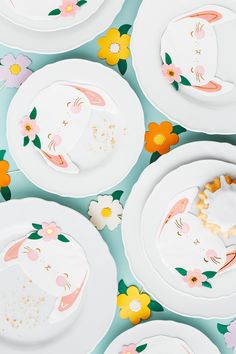 white plates with pink and yellow flowers on them