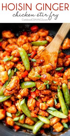 chicken stir fry with green beans and carrots in a skillet, topped with a wooden spoon