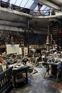 a room filled with lots of clutter and wooden shelves covered in items like books