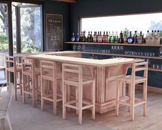 an empty bar with stools and bottles on the counter