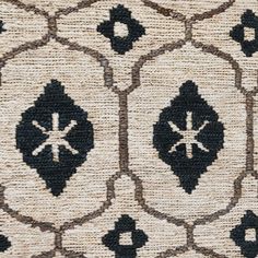 an area rug with black and white designs on it