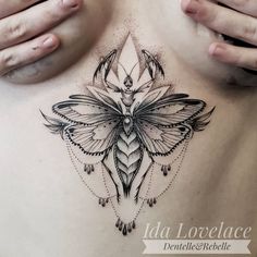 a woman's stomach with a butterfly tattoo on it, and an intricate design