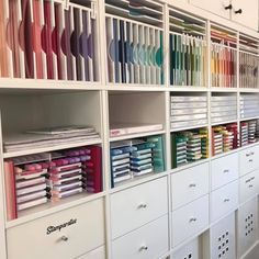 the shelves are filled with many different types of crafting supplies and paper rolls on them