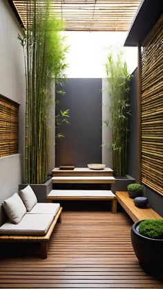 an outdoor living area with bamboo trees and benches in the center, surrounded by wood flooring