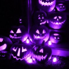 halloween pumpkins lit up in purple light