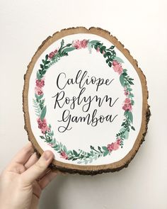 someone is holding up a piece of wood with the words califope roslyn samboa on it