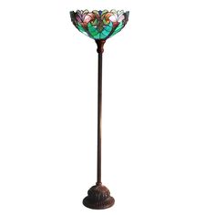 a stained glass floor lamp on a metal pole with an iron base and flower design