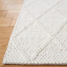 a white rug is laying on the floor