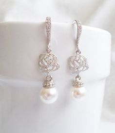 These lovely enchanted rose earrings with Swarovski pearl drops are so romantic! They are a great choice for any bride! They have just a touch of sparkle, with a luminous pearl dangling below! They are great for after the wedding too! Scroll down for details, packaging and shipping, international orders, more products and other important links! PLEASE NOTE: All earrings sales are final for hygienic reasons. Thank you for understanding! DETAILS I made these beautiful earrings with: ♥ 8mm Swarovsk Elegant Sterling Silver Rose Design Earrings, Elegant Rose Design Earrings For Wedding, Silver Rose Design Earrings For Wedding, Elegant Rose Design Drop Earrings, Elegant Rose Design Wedding Earrings, Dangle Earrings With Rose Design For Wedding, Bridal Drop Earrings, Pearl Bridal Earrings, Teardrop Bridal Earrings